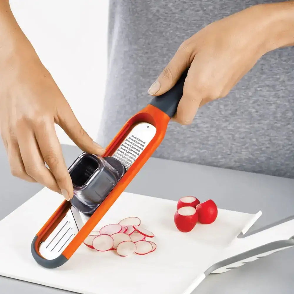 Person using a vegetable peeler on radishes with a white background