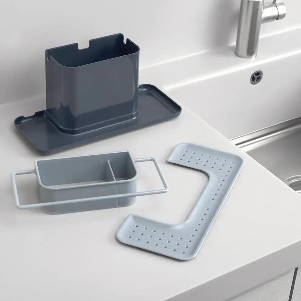 Set of gray kitchen sink organizers on a white countertop.
