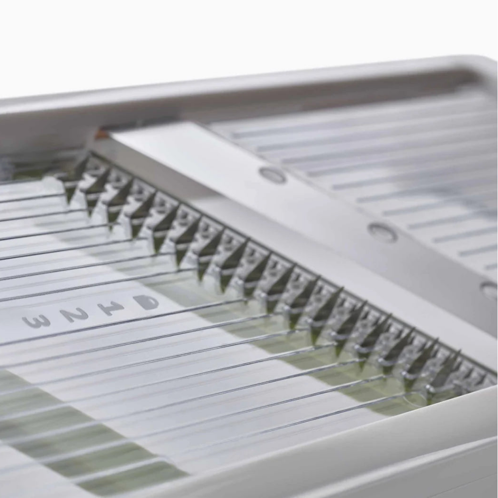 Metallic tray with a grid pattern on a white background