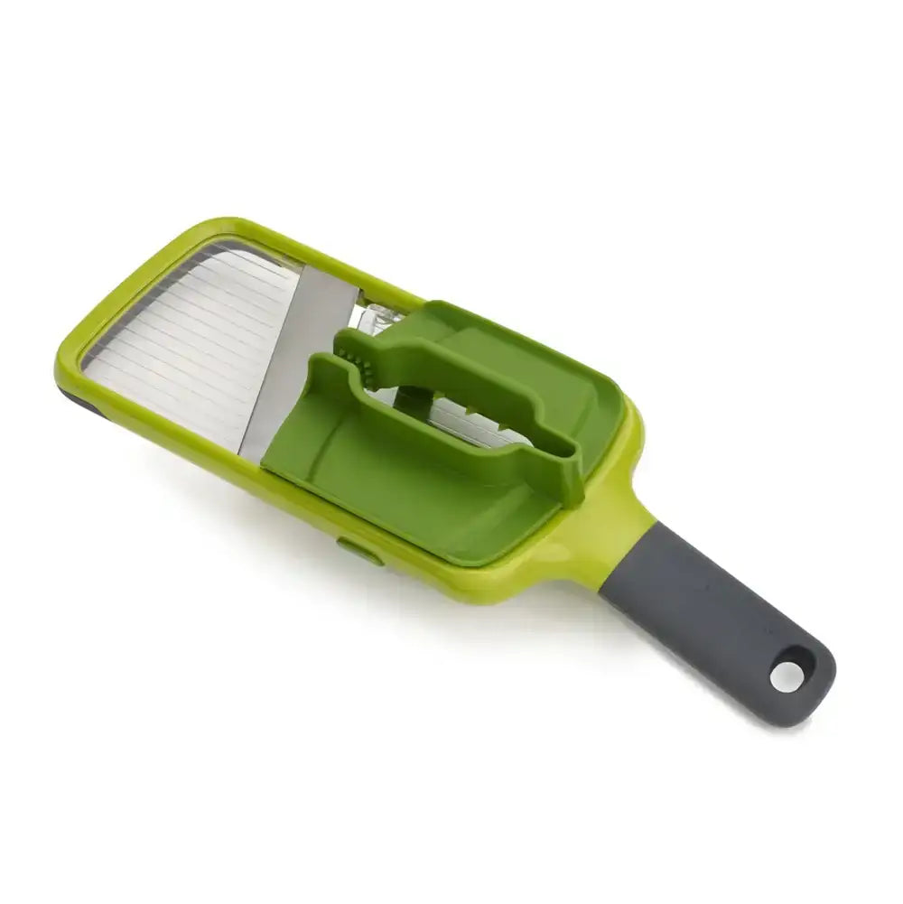 Green vegetable chopper with a gray handle on a white background