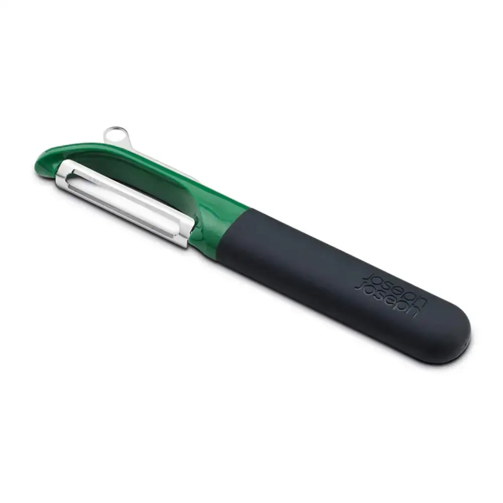 Green and black vegetable peeler with silver blade on a white background