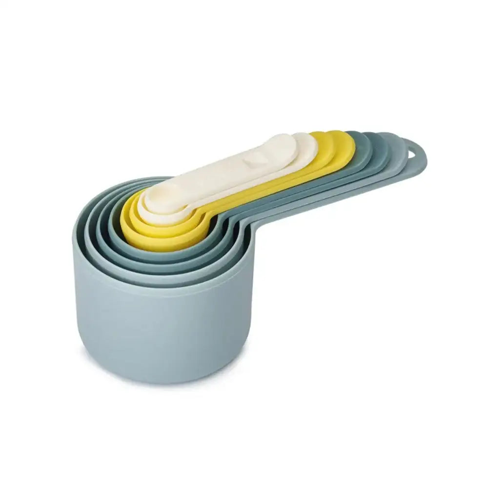 Set of colorful measuring cups on a white background