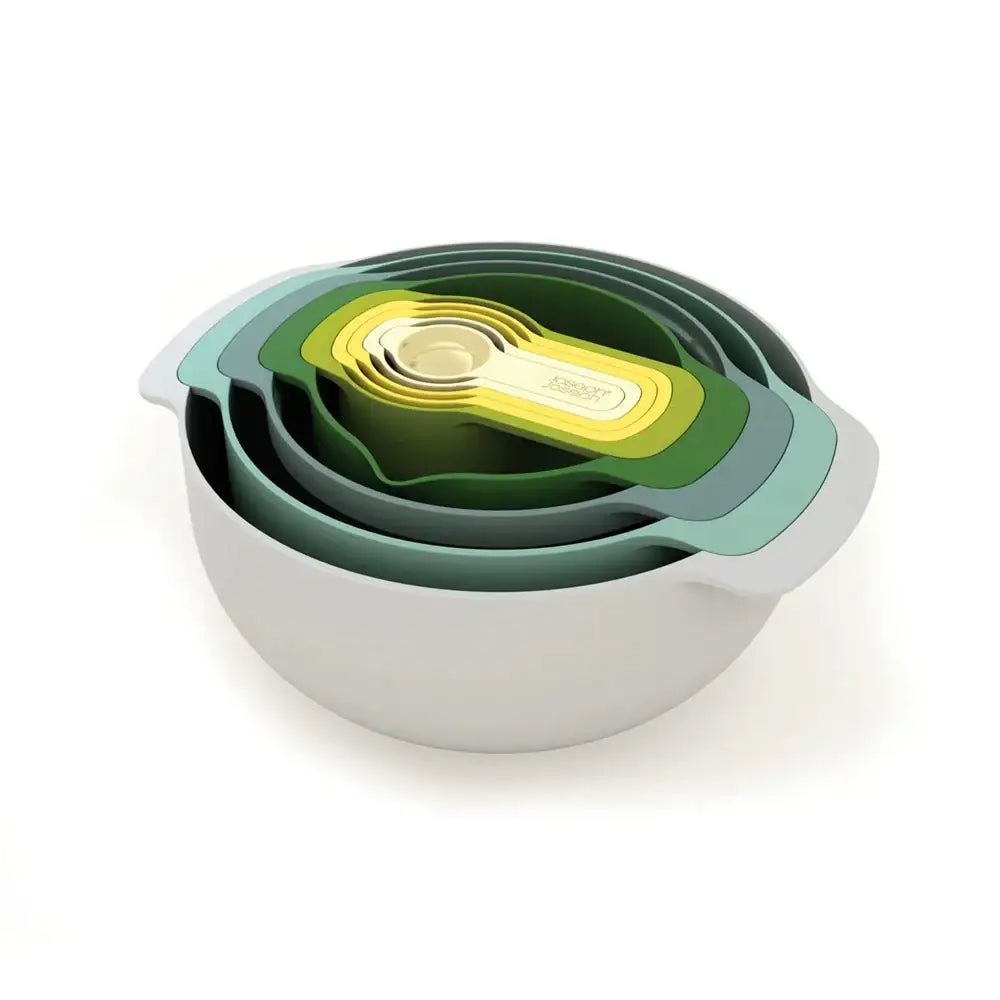 Set of nesting bowls with green and white design on a white background