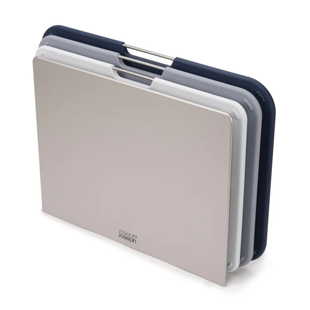 Set of three cutting boards in beige, white, and navy on a white background