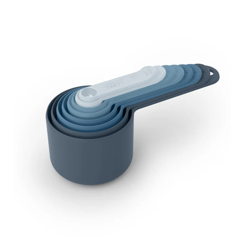 Set of blue measuring cups stacked on a white background