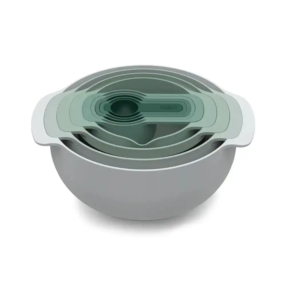 Set of green and gray nesting bowls with lids on a white background
