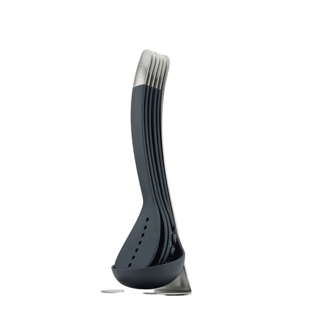 A modern multi-piece utensil set with a dark gray and silver metal handles, standing on a matching base against a white background.