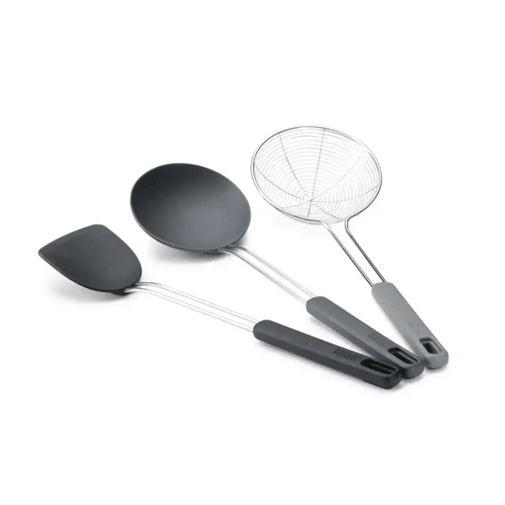 Set of four kitchen utensils including a spatula, ladle, and two skimmers on a white background.