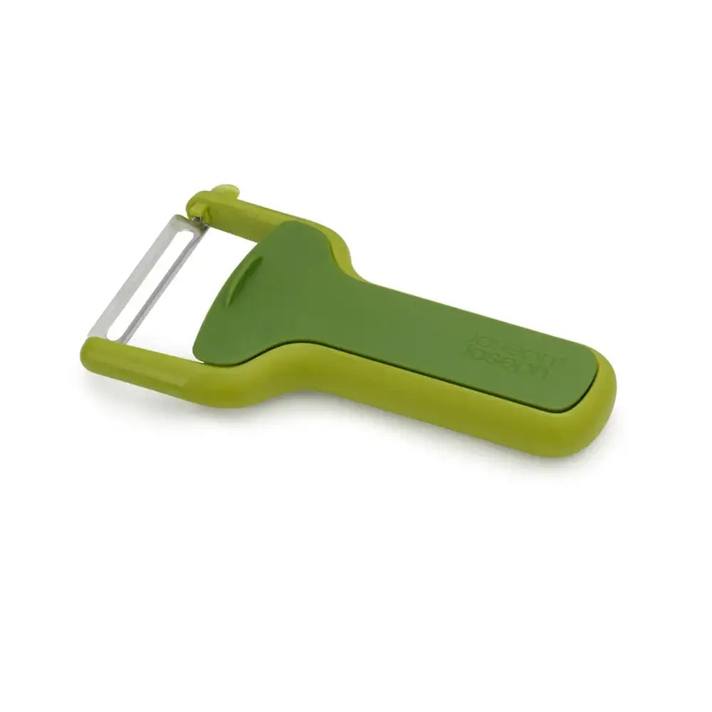 Green vegetable peeler on a white background