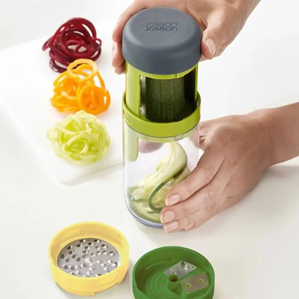 Hand using a spiralizer to create zucchini noodles on a white background