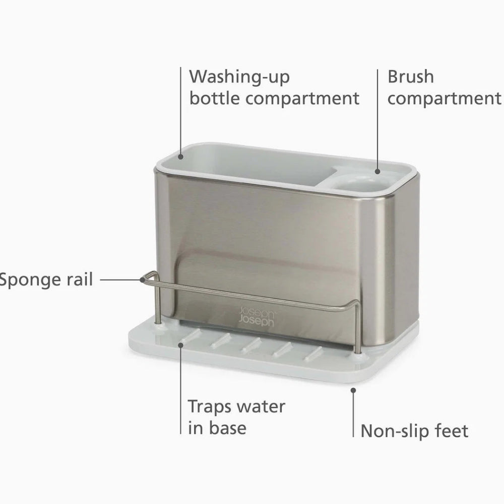 A stainless steel and white dish drying stand with labeled callouts pointing to its features: washing-up bottle compartment, brush compartment, sponge rail, traps water in base, and non-slip feet.
