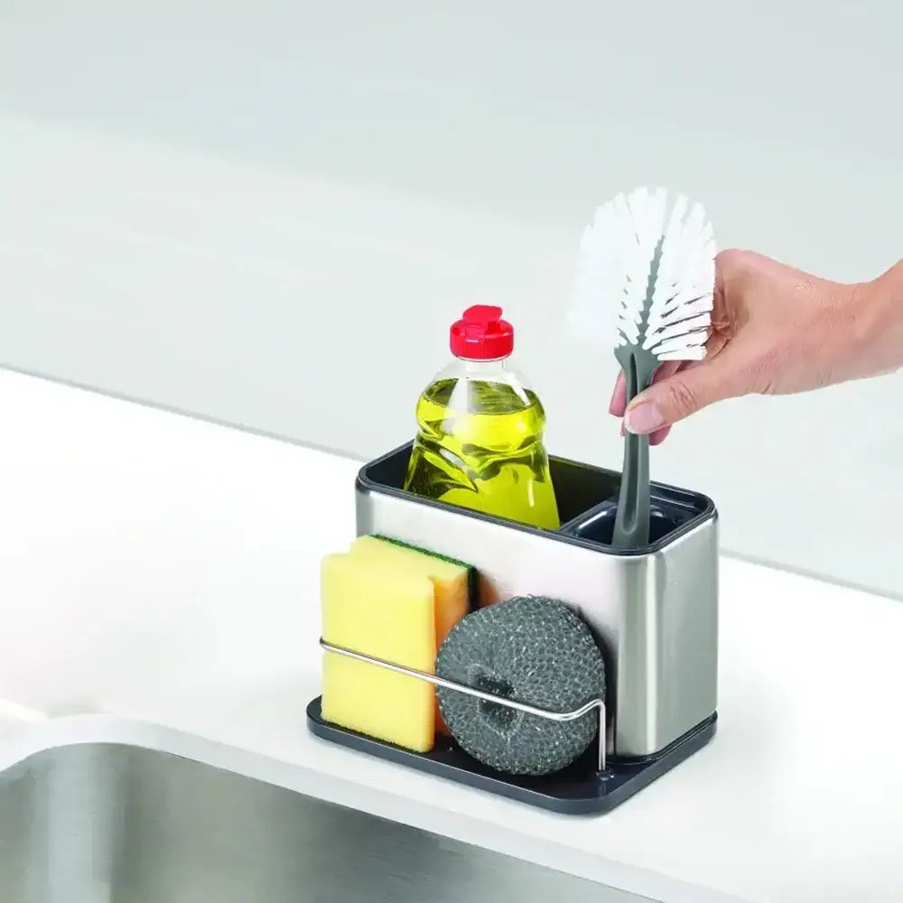 Kitchen sink caddy with cleaning supplies on a white countertop