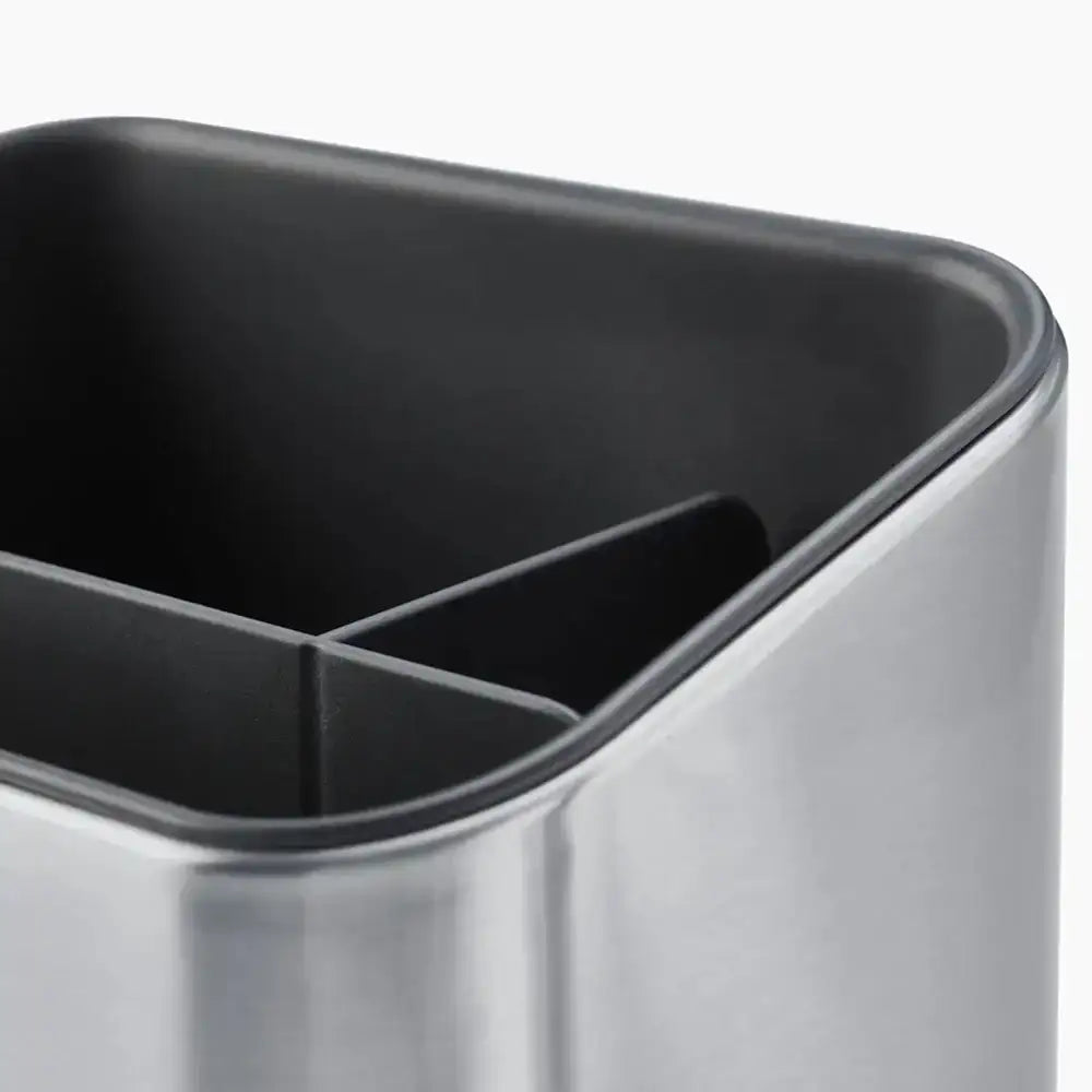 Close-up of a metallic container with black interior