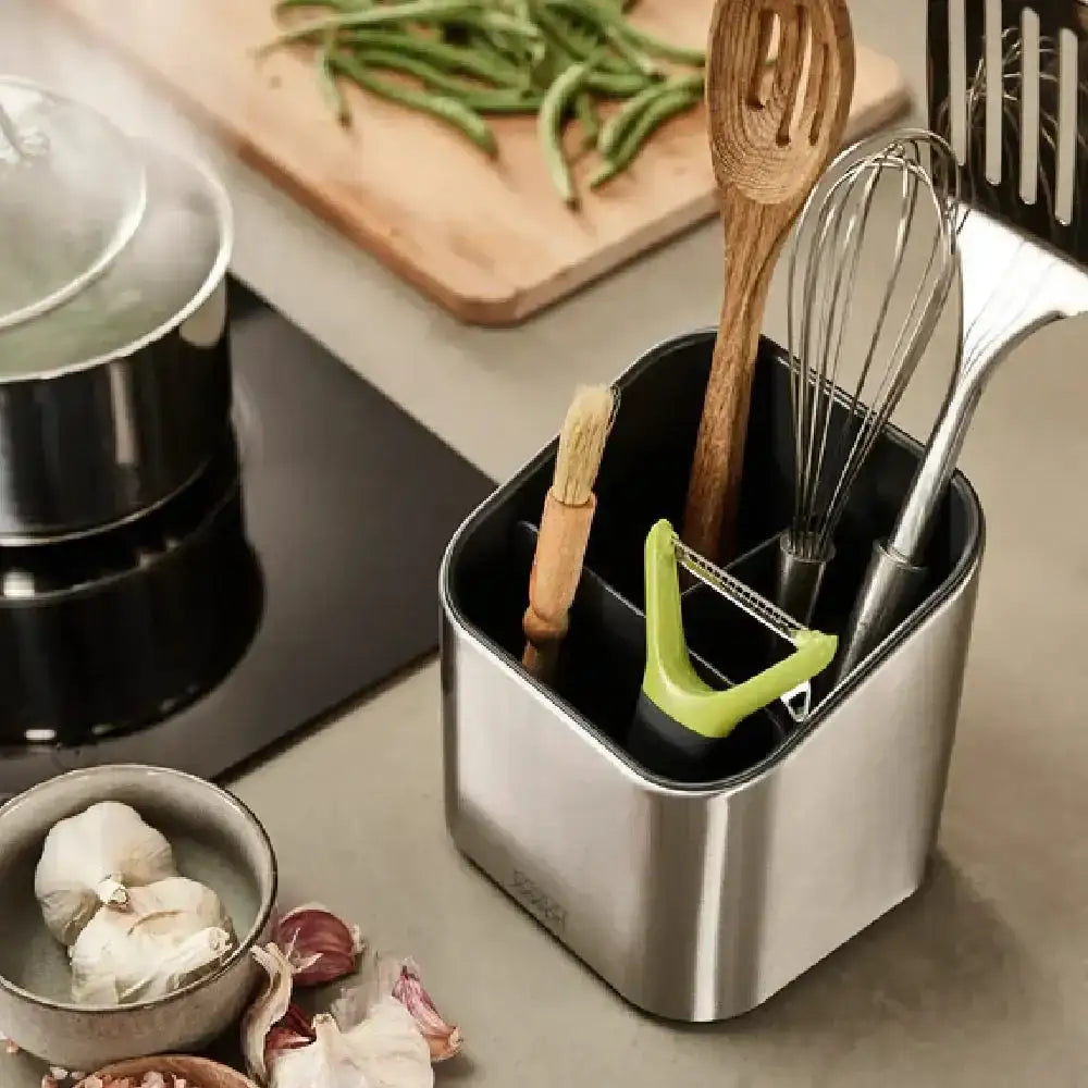 Kitchen utensil holder with utensils on a kitchen counter