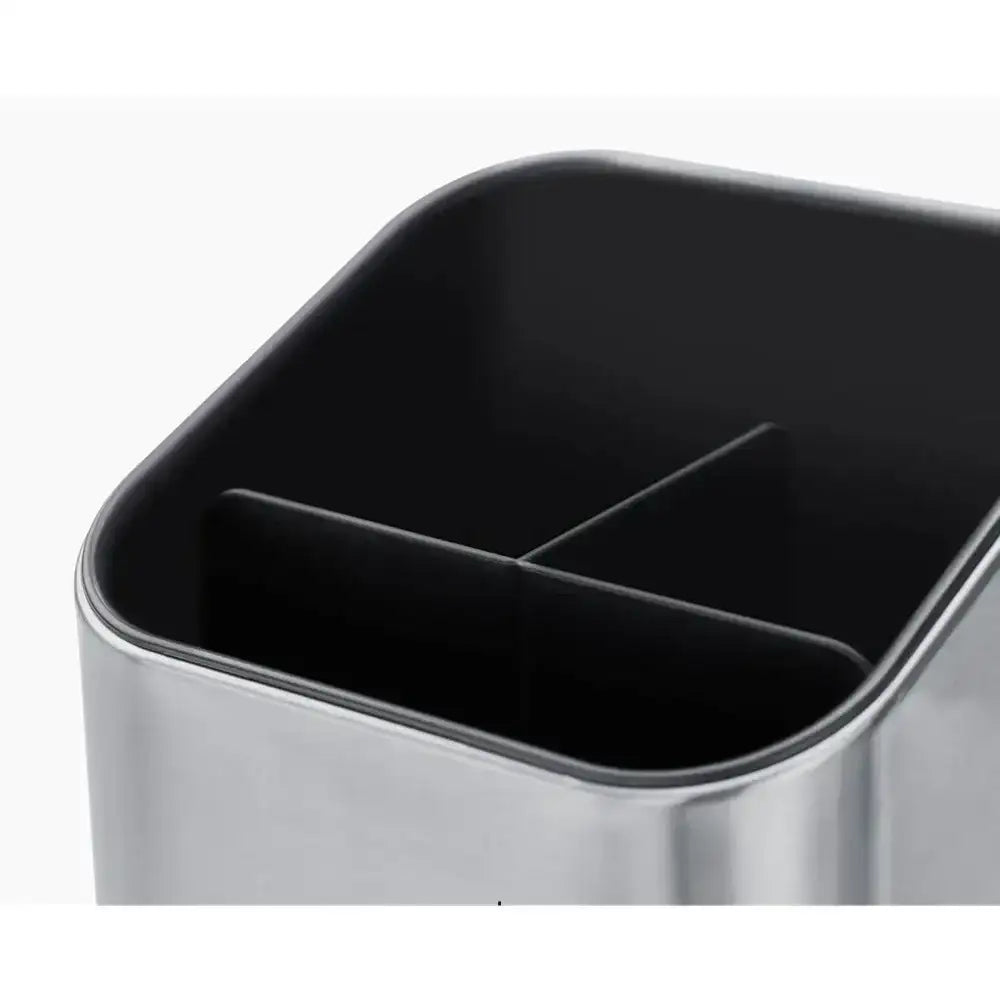 Black rectangular container with a metallic base on a white background