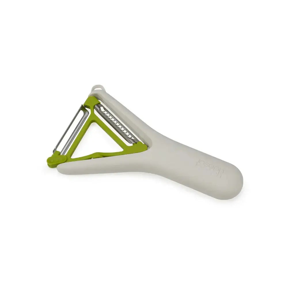 Peeler with green handle and white body on a white background