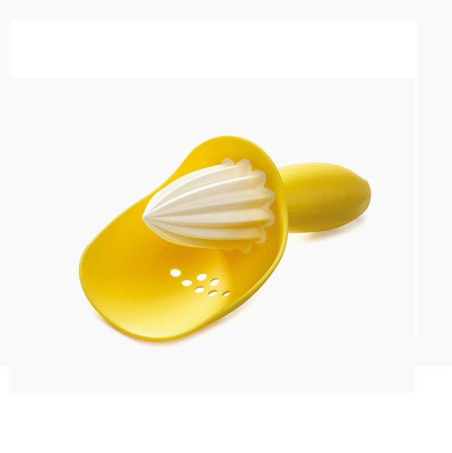 A yellow citrus juicer with a white conical reamer and a small yellow handle, shown on a plain white background.