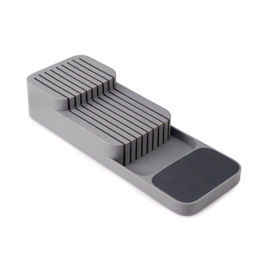 A gray plastic in-drawer knife organizer with a slatted top and a dark gray non-slip pad, shown on a plain white background.