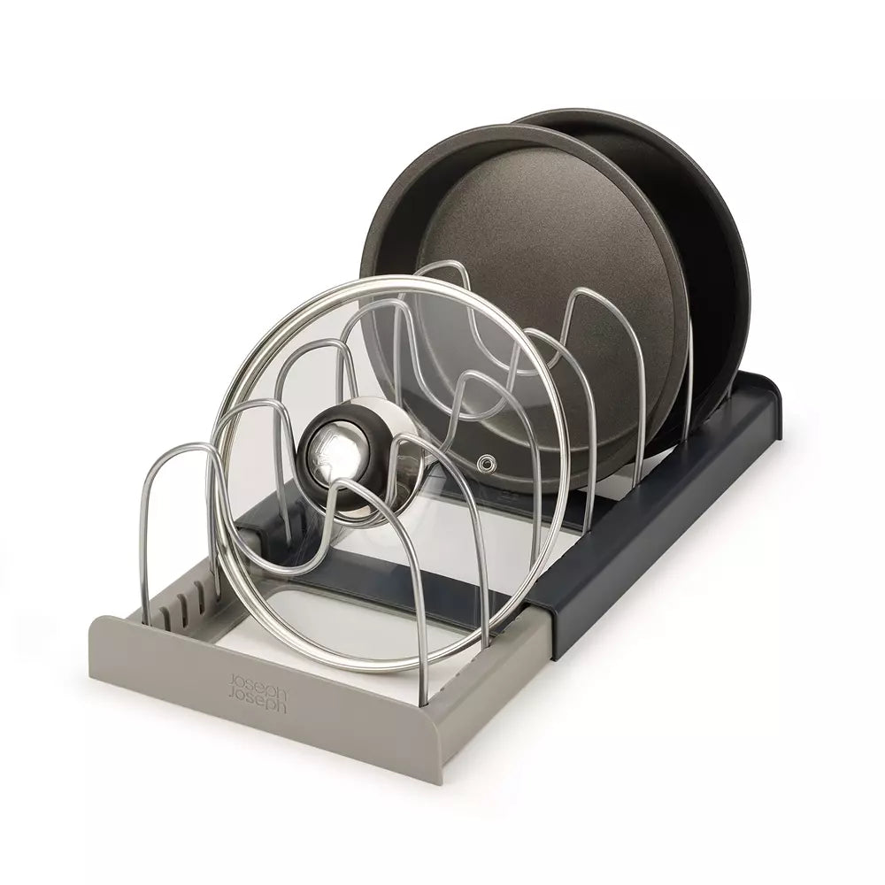 In-drawer cookware organizer with plates and lids on a white background
