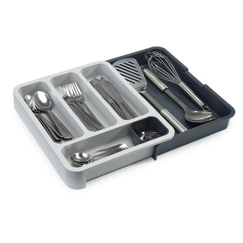 Gray cutlery organizer with silver utensils on a white background