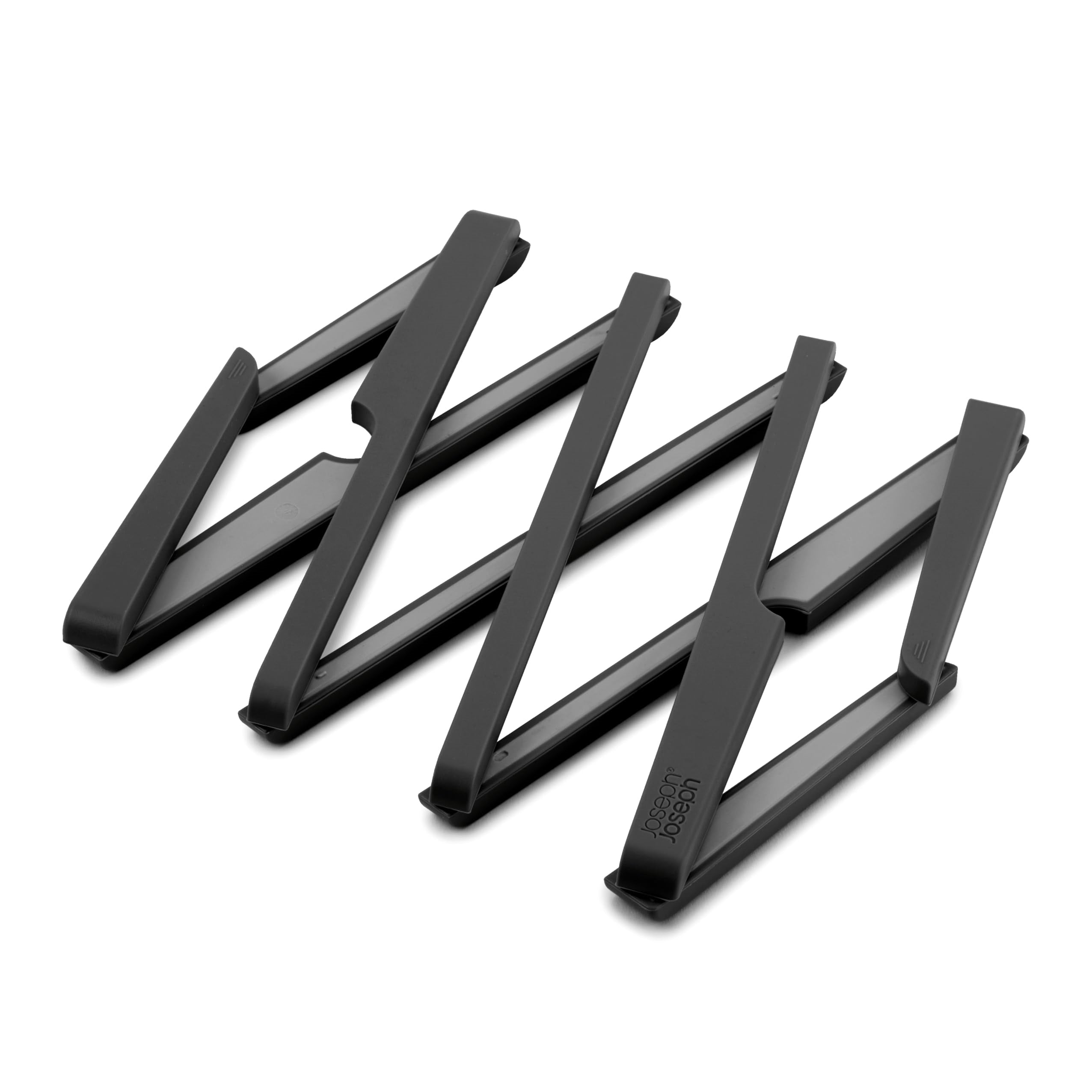 Black expandable table trivet with a zigzag design with a "Joseph Joseph" logo, shown on a clean white background.