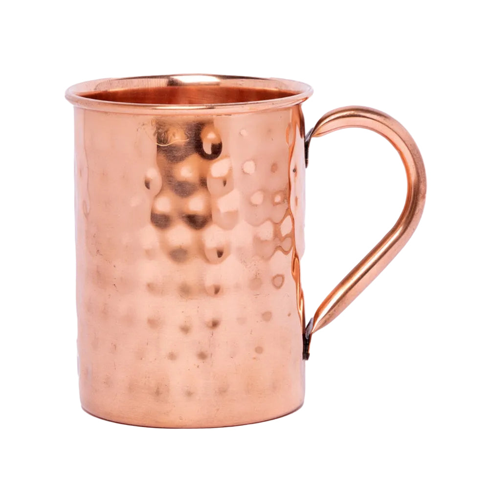 A hammered copper Moscow Mule mug with a curved handle, shown on a plain white background.