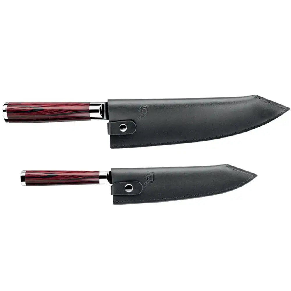Two chef's knives with black sheaths on a white background