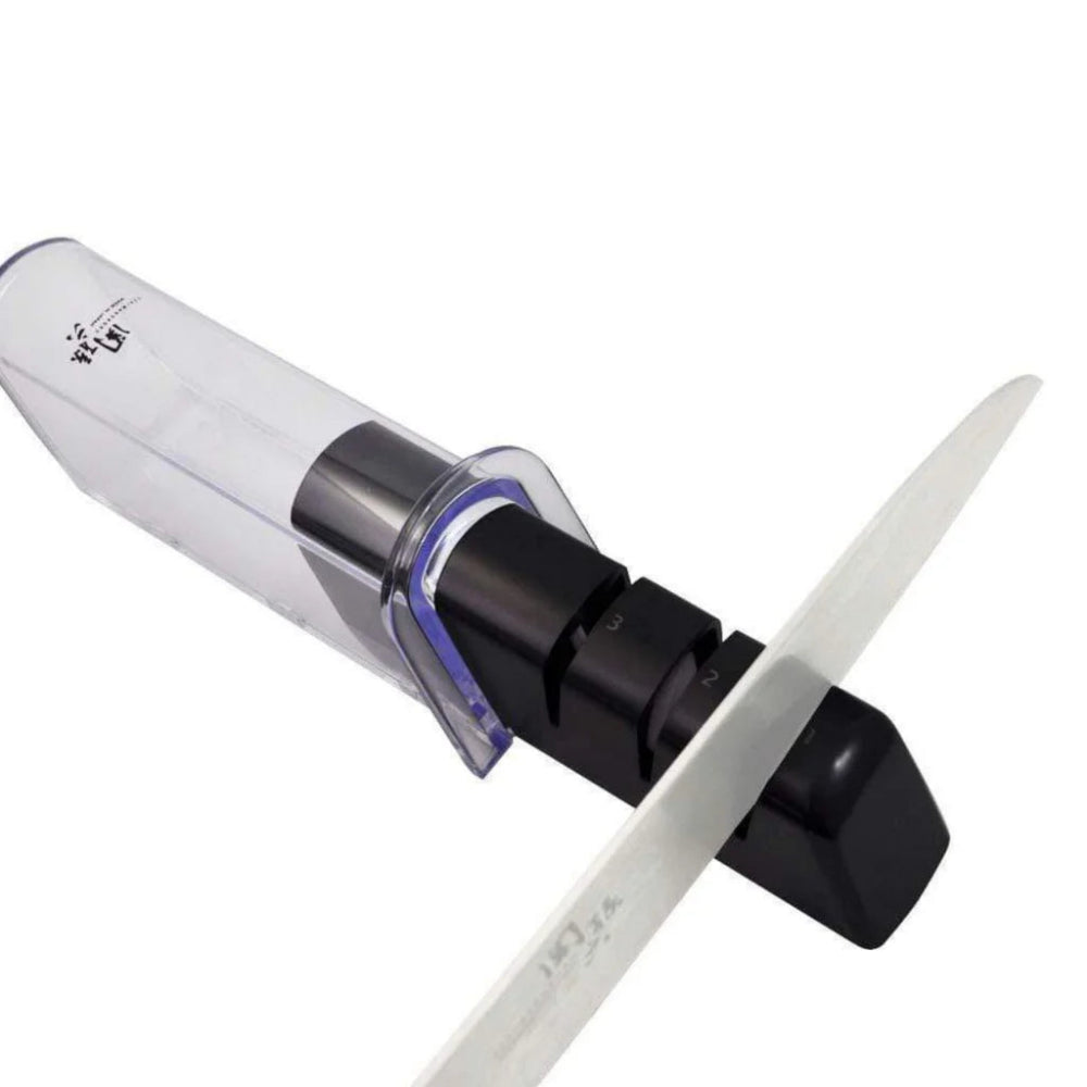 Knife sharpener with a white handle and black base on a white background