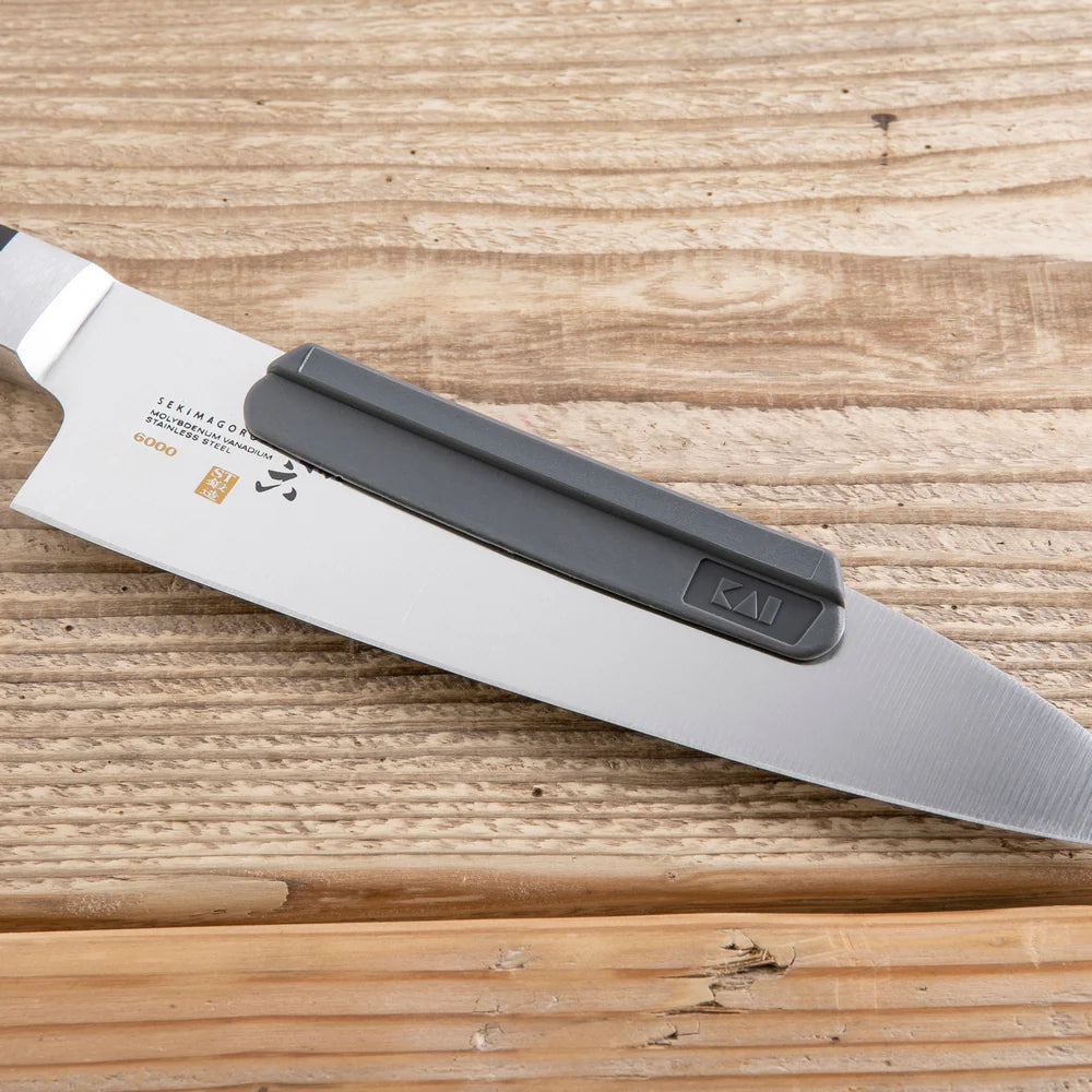 Kai Shun sharpening aid on a knife, on a table