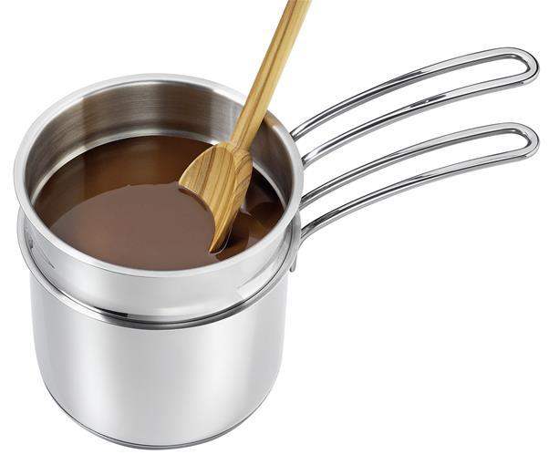 Stainless steel pot with a wooden spoon stirring a brown liquid on a white background