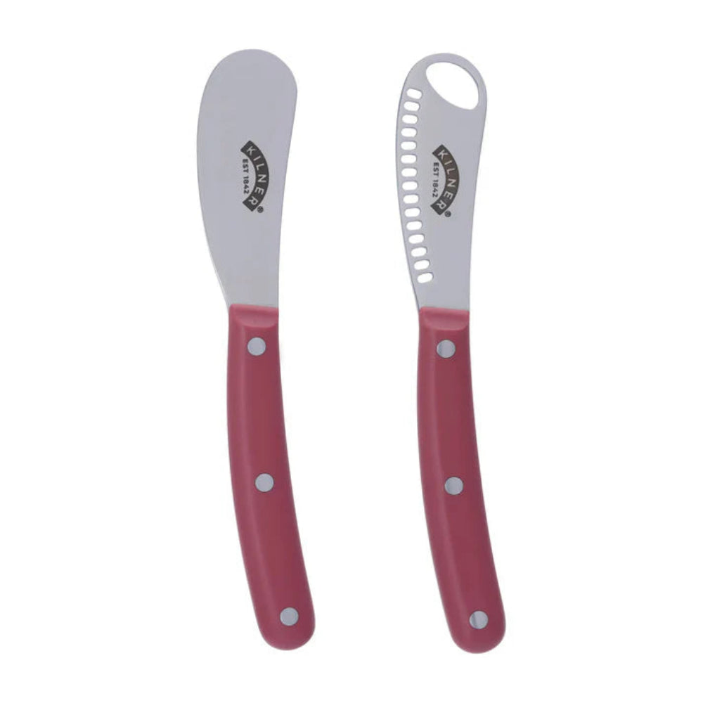 Two kitchen utensils with red handles and silver blades on a white background