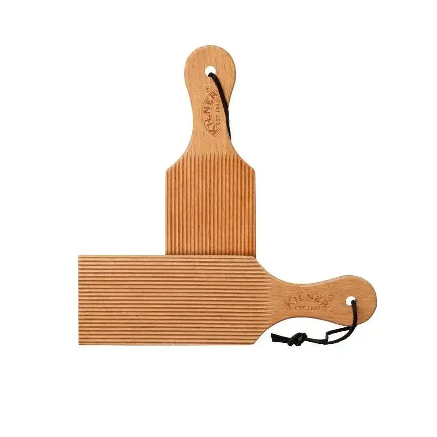 Wooden paddle with textured surface on a white background