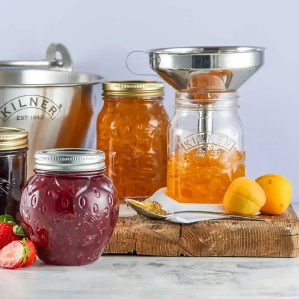 Kilner jars with jam and honey on a wooden board with fruits