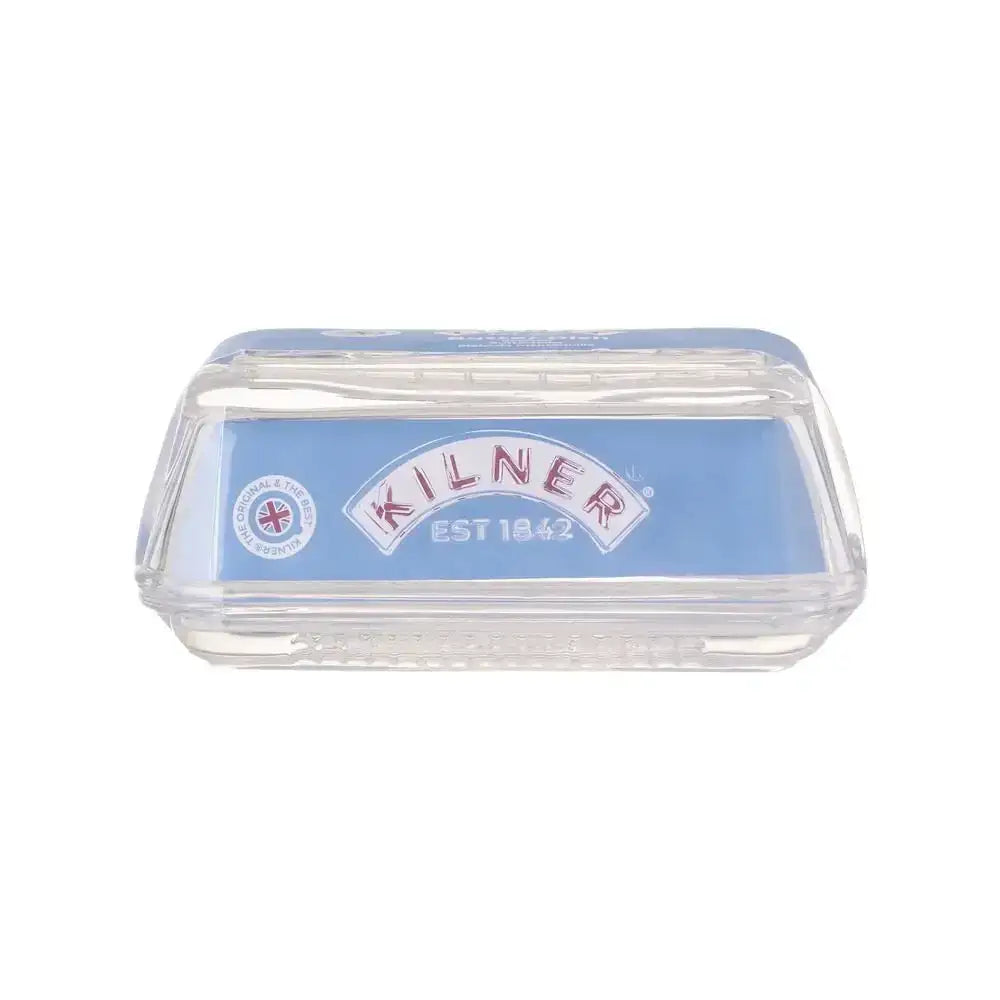 Clear glass butter dish with Kilner EST 1842 branding on a blue background.