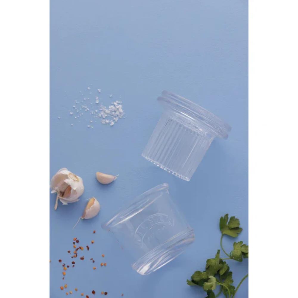 Clear glass containers with lids on a blue background