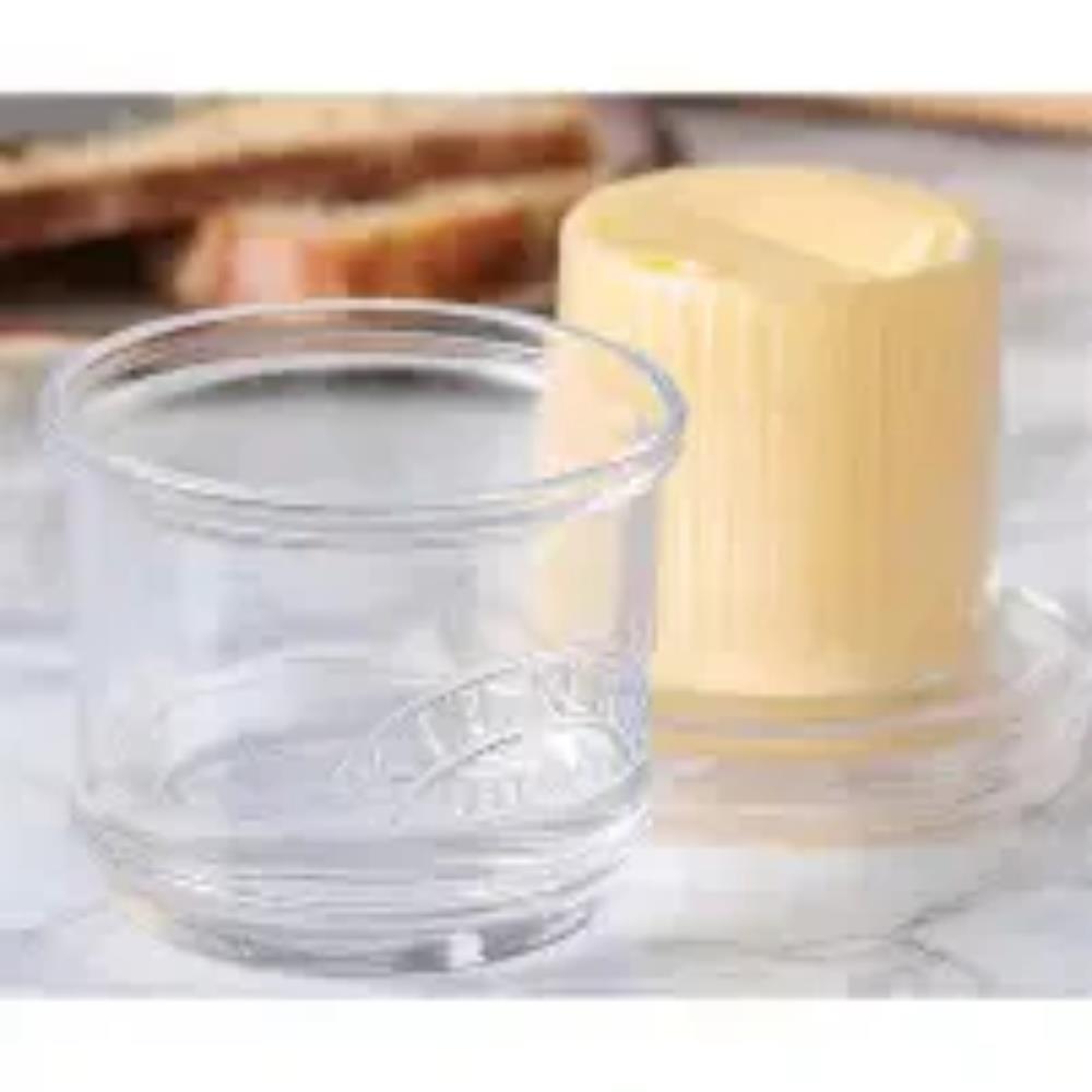 Butter in a glass container on a marble surface