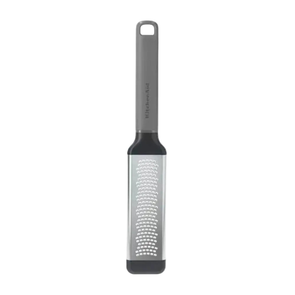 A vertical kitchen grater with a matte gray handle, black collar, and a silver metal grating body with black end caps, shown on a plain white background.