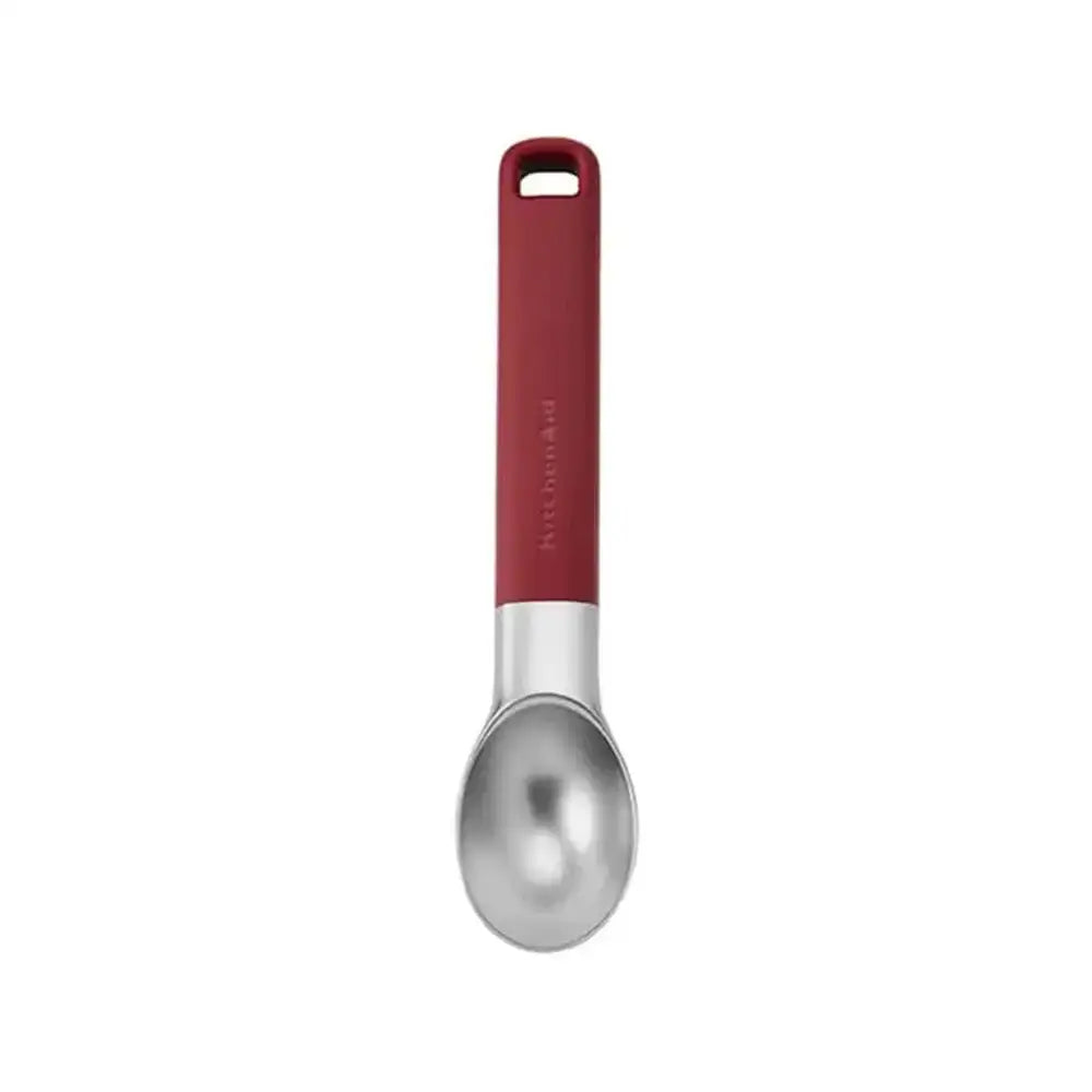 Spoon with red handle on a white background