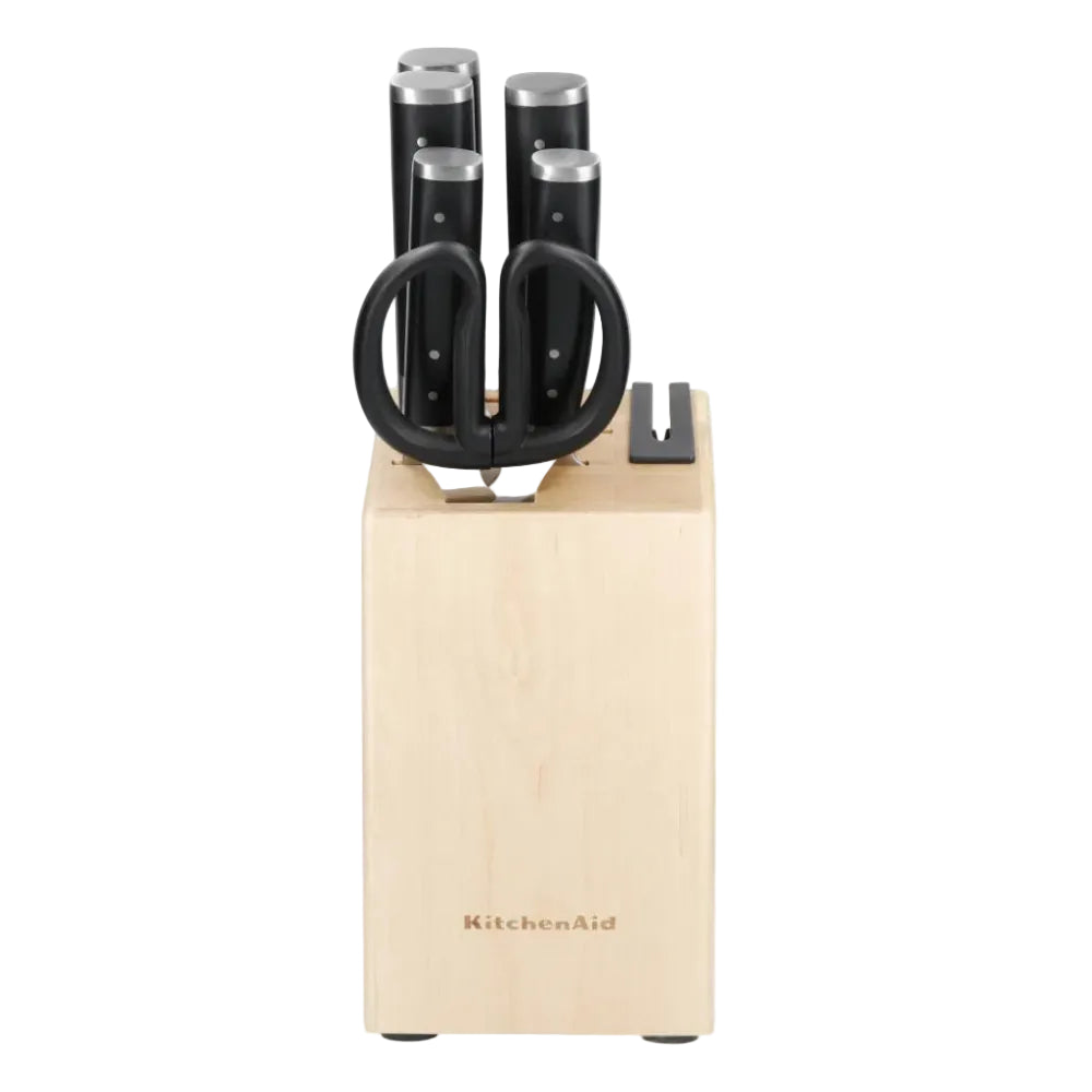 Set of knives in a wooden block with 'KitchenAid' branding on a white background