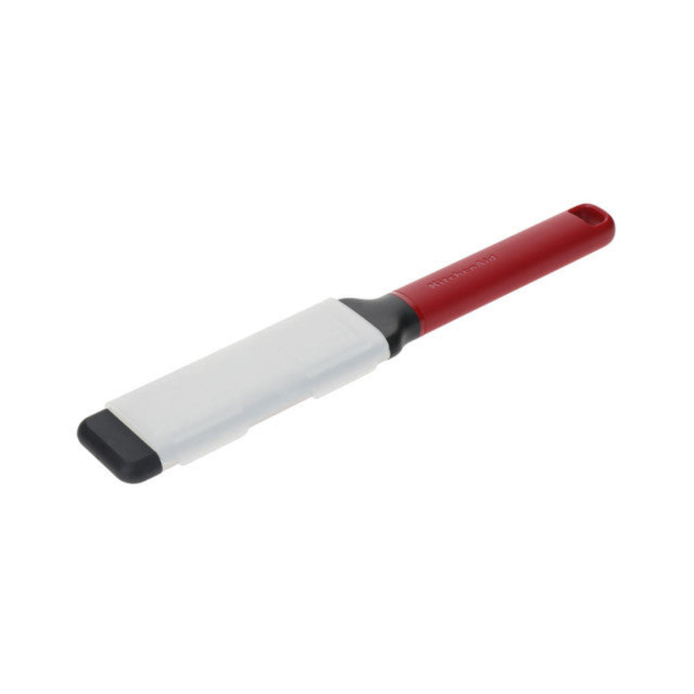 Red and white kitchen tool on a white background