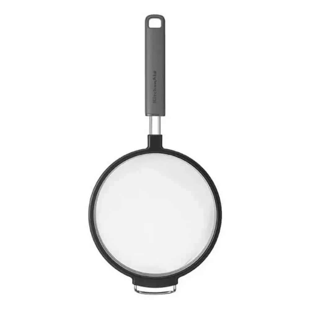 Black frying pan with a glass lid on a white background