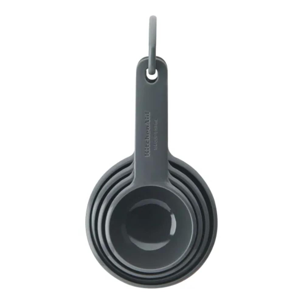 Set of gray measuring cups with a hanging hook on a white background