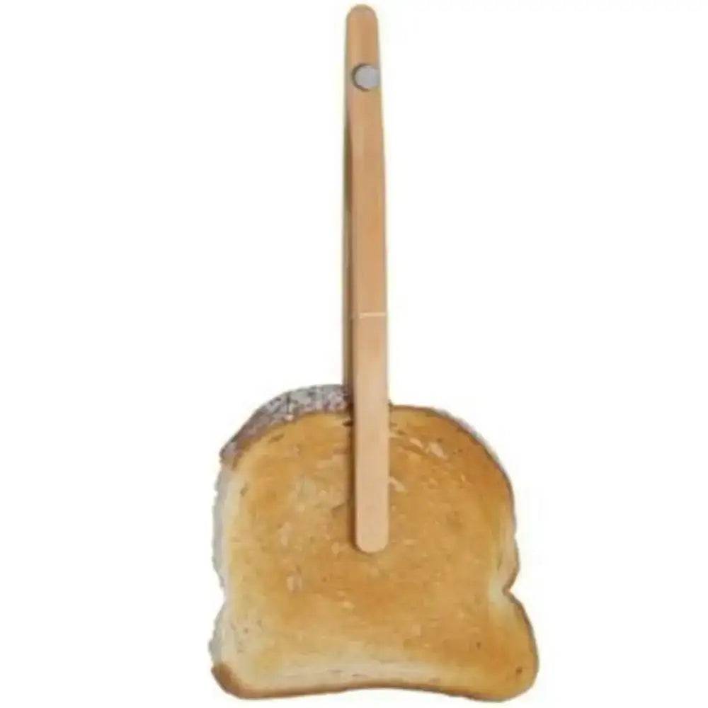 Wooden food tongs holding a piece of toast on a white background