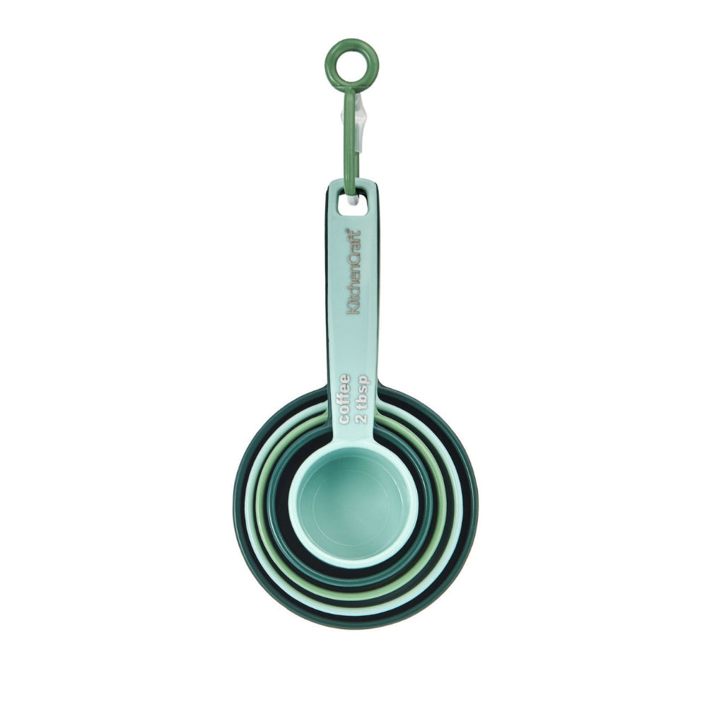 Set of green measuring cups with a hook on a white background