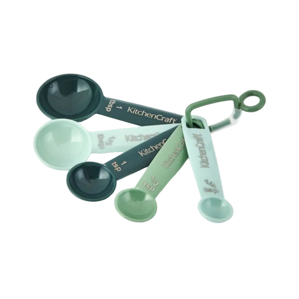 Set of green measuring spoons with 'KitchenCraft' branding on a white background