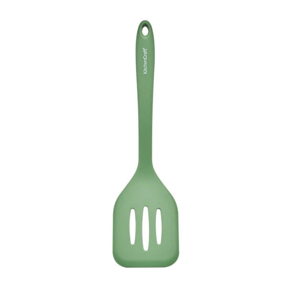 Green slotted spatula on a white background