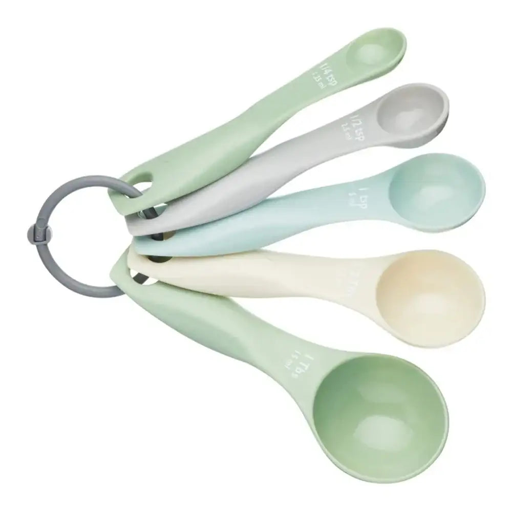Set of measuring spoons in pastel colors on a white background