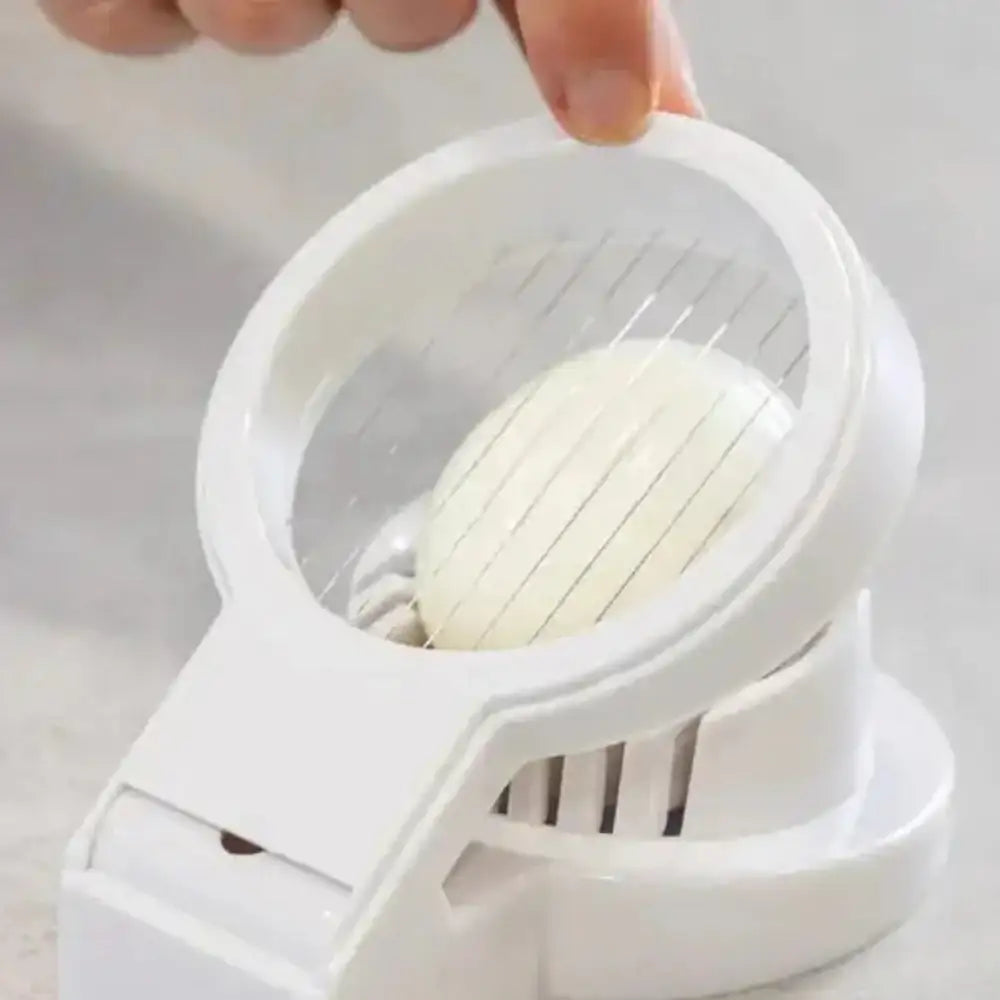 White egg slicer with an egg being sliced on a light gray background
