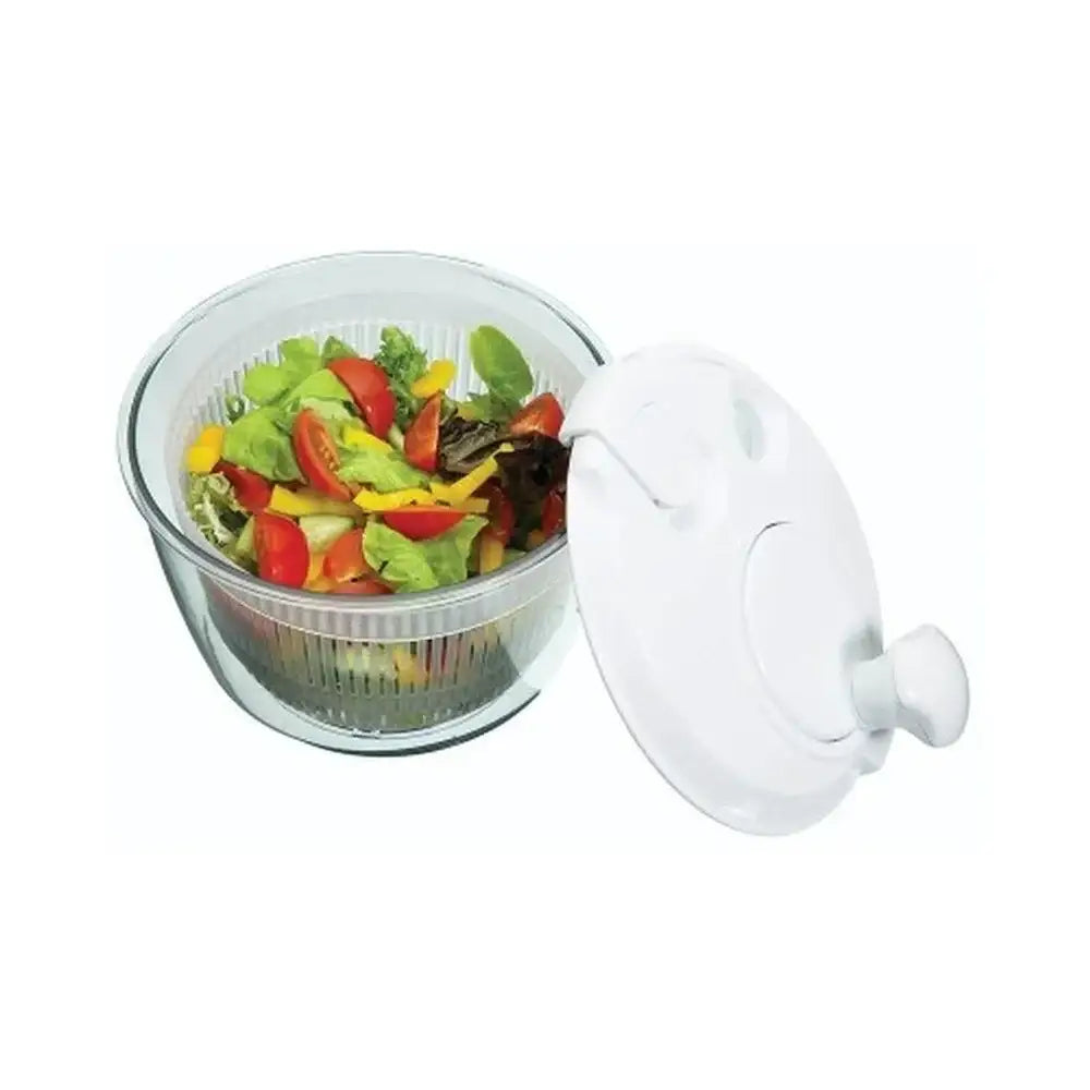 Salad spinner with fresh vegetables on a white background