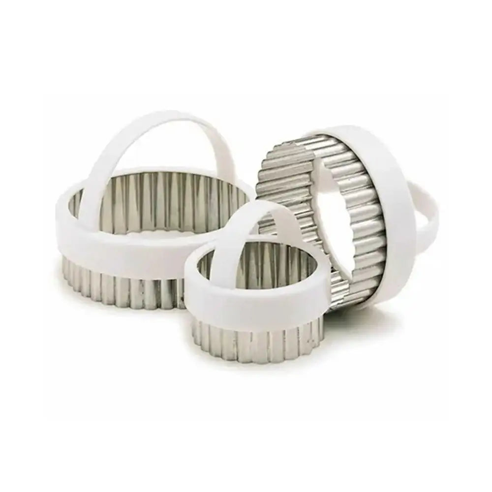 Three metallic kitchen tools with white handles on a white background